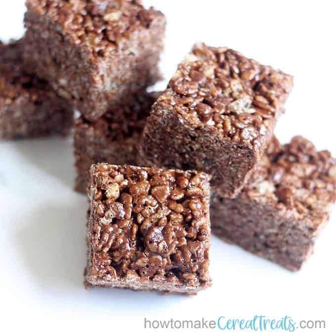 f chocolate rice krispie treats stacked with white background 