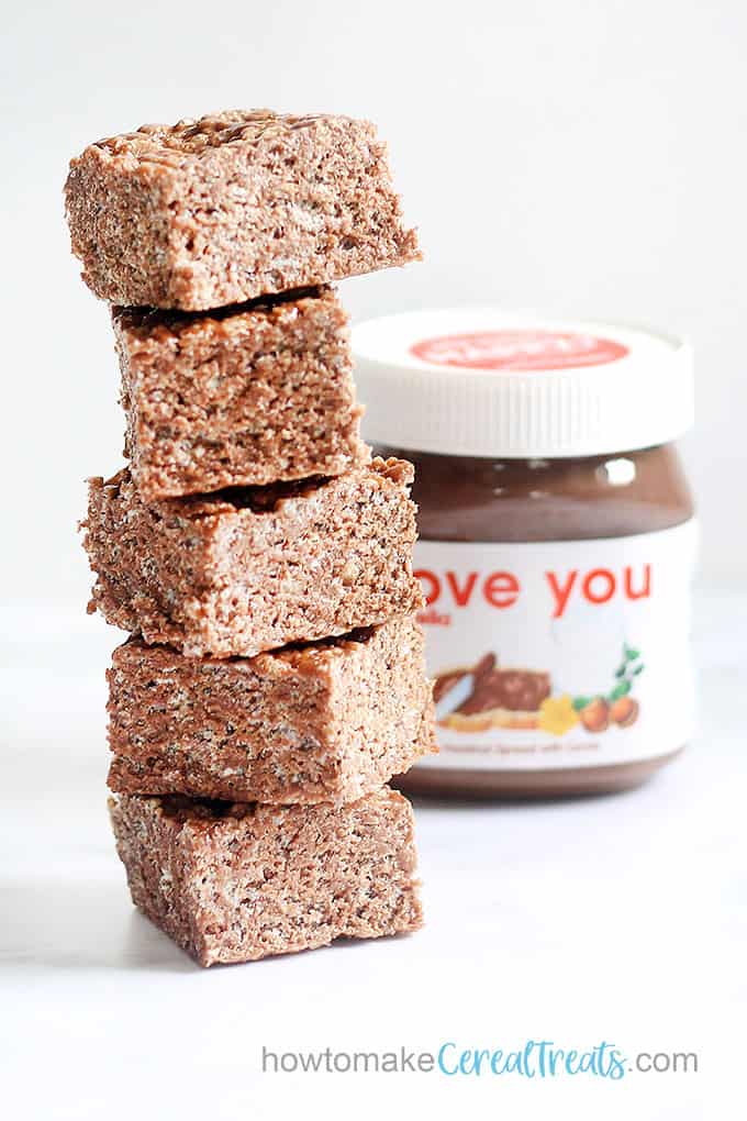 Stacked Nutella Rice Krispie treats with jar of Nutella 