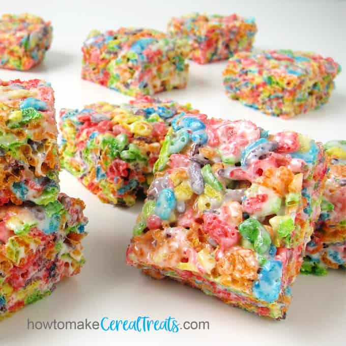 a closeup of the top angle of a Fruity Pebbles Rice Krispie Treat that shows all the whole pieces of cereal on top combined with the gooey marshmallow