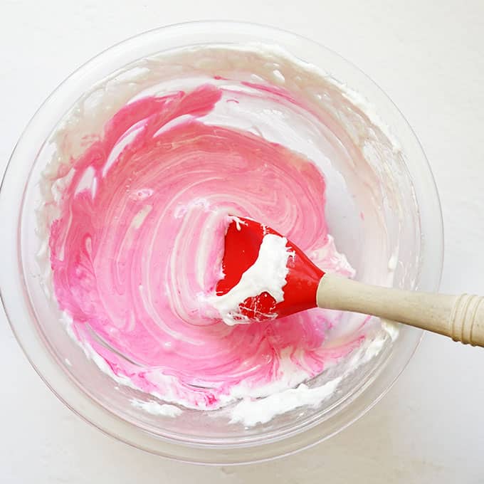 mixing pink into marshmallows for rice krispie treats