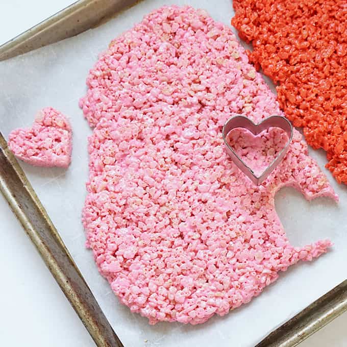 cutting out pink and red heart rice krispie treats