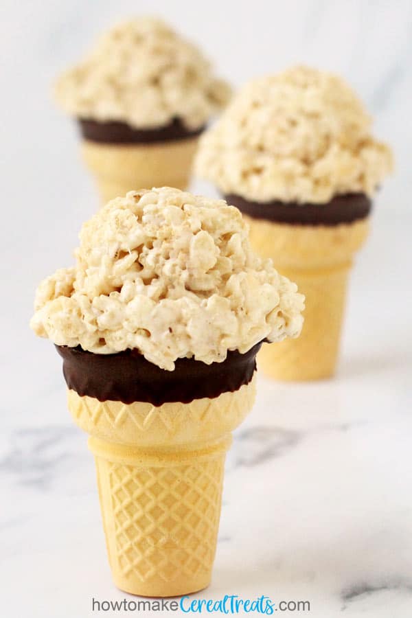 chocolate dipped ice cream cone topped with rice krispie treats