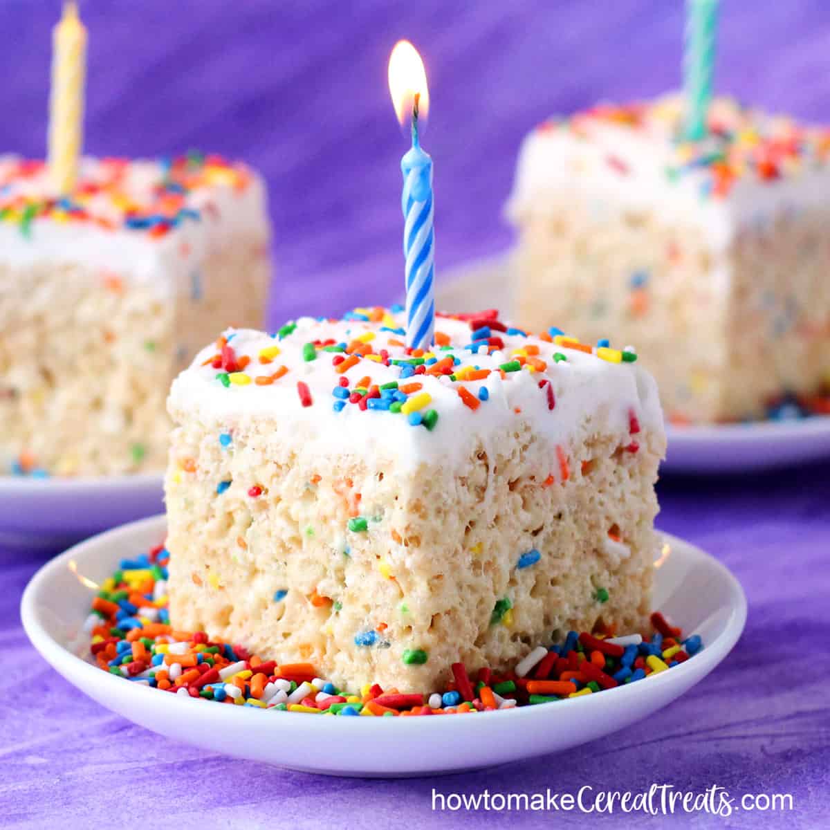 birthday cake rice krispie treats with frosting, sprinkles, and birthday candles