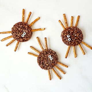 HALLOWEEN RICE KRISPIE TREAT SPIDERS -- Turn rich, delicious chocolate cereal treats into scary spiders for Halloween.