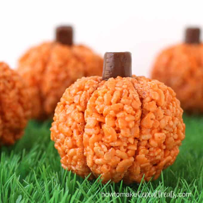 orange rice krispie treat pumpkins arranged on green grass