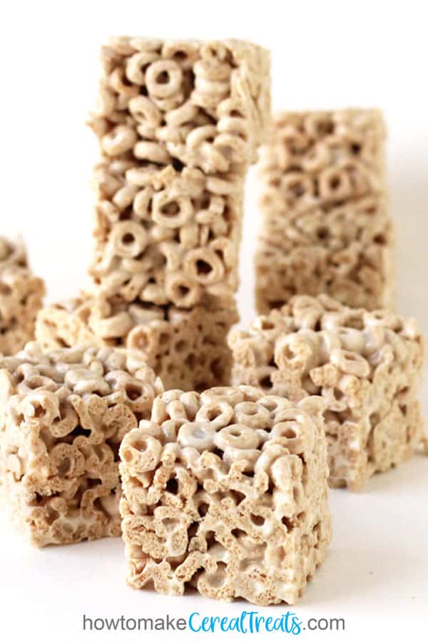Cheerios Bars made with marshmallows, Cheerios cereal, and butter are cut into square bars.