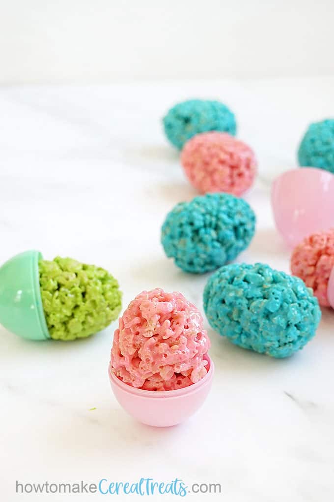 Pink, green, and blue Easter egg Rice Krispie treats shaped with plastic eggs 