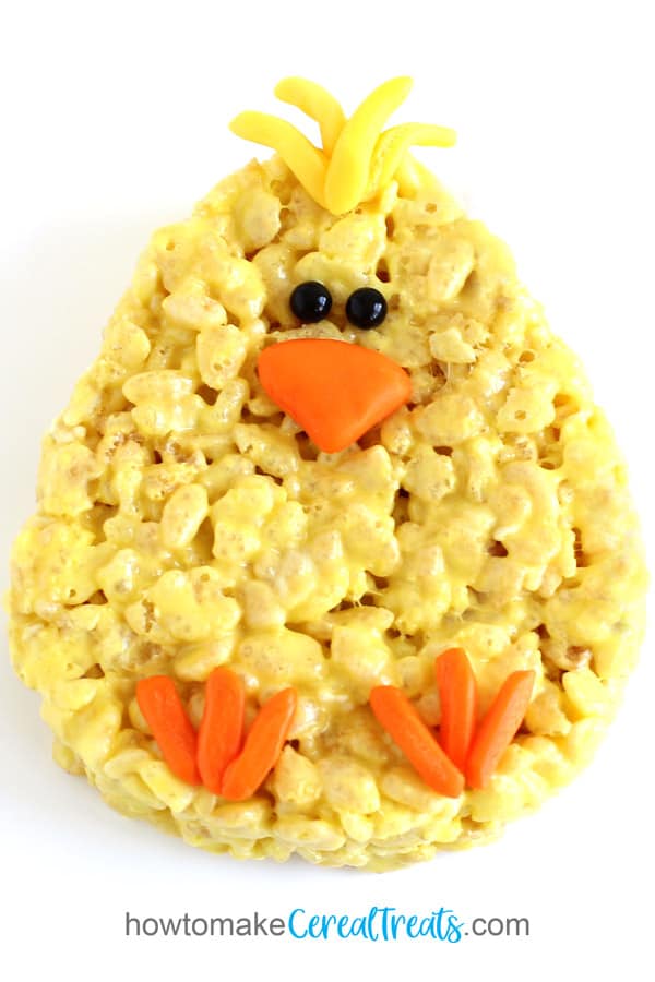Yellow Rice Krispie Treat Chick with candy beak, feet, feathers, and eyes.