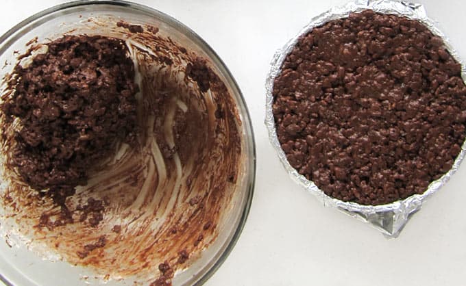 Fill a round tin foil-lined bowl with Cocoa Krispies Treat mixture.