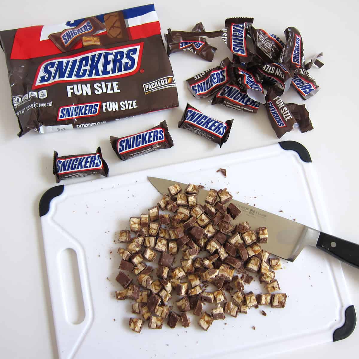 chopping fun size Snickers candy bars into small pieces. 
