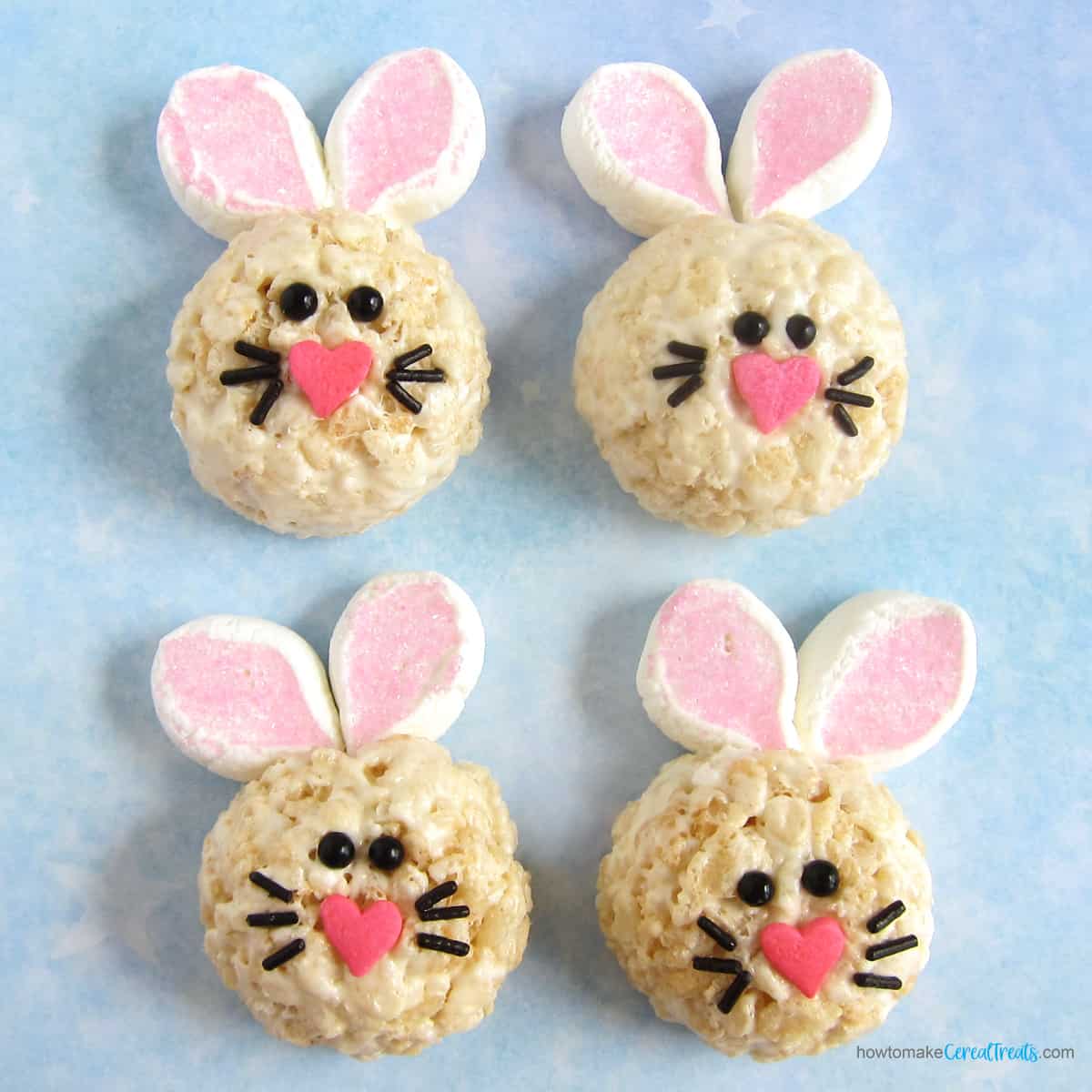 rice crispy treat bunnies with marshmallow ears, heart-shaped noses, candy eyes, and sprinkle whiskers