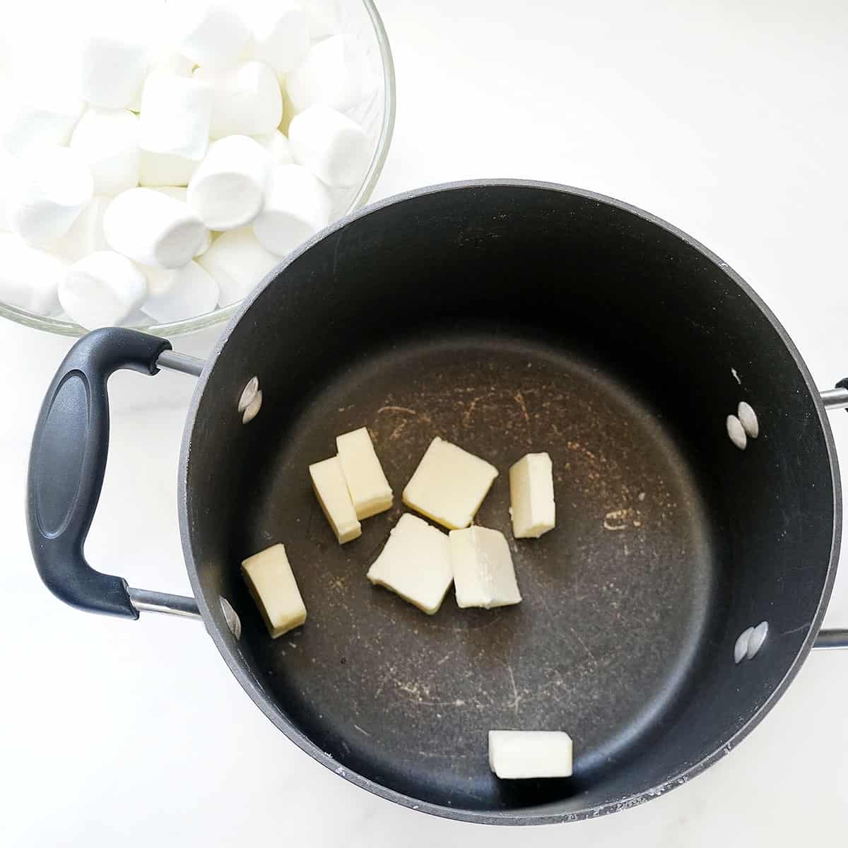 Melting butter in sauce pan and marshmallows for Rice Crispy treats 