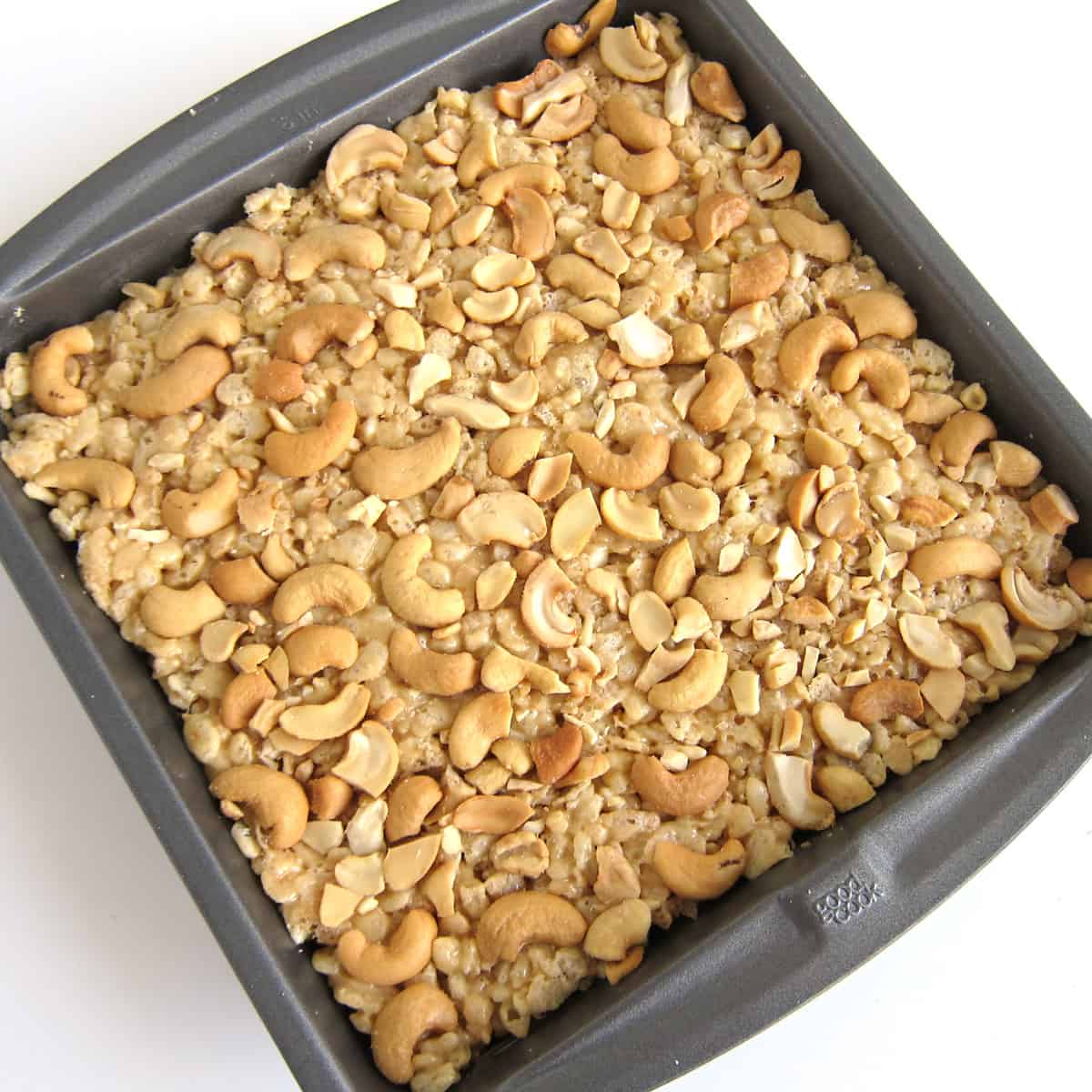 pan of cashew butter rice crispy treats topped with cashew pieces