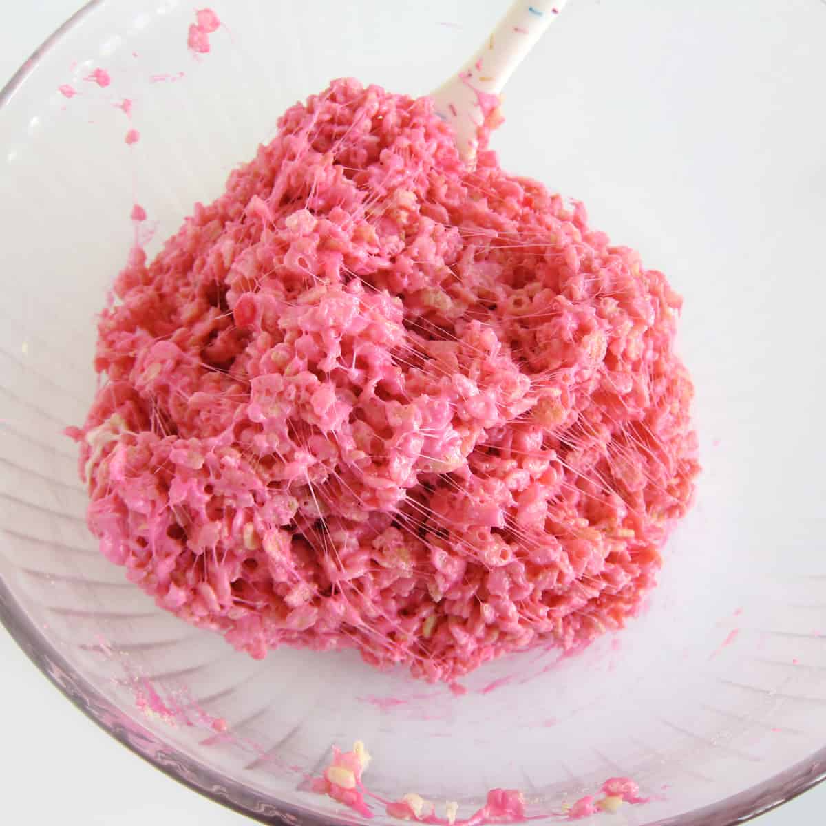 neon pink colored rice krispie treat mixture in a bowl