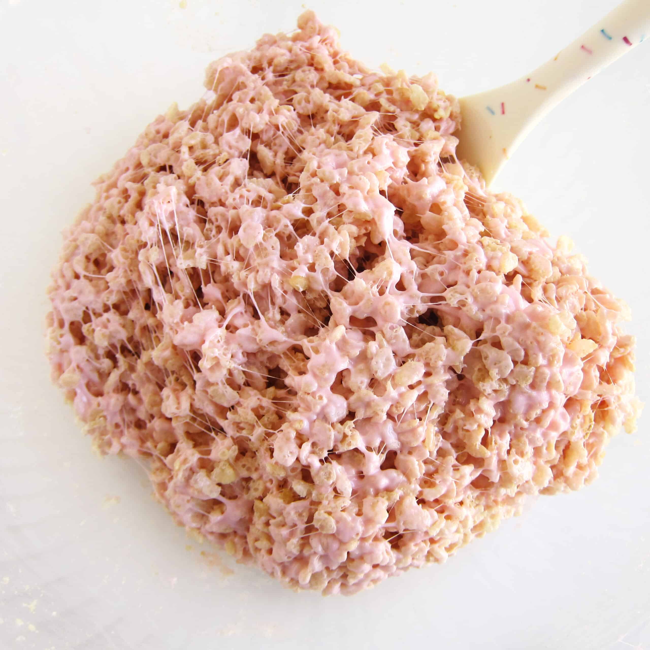 Rice Krispies cereal mixed with pink-colored melted marshmallows and butter