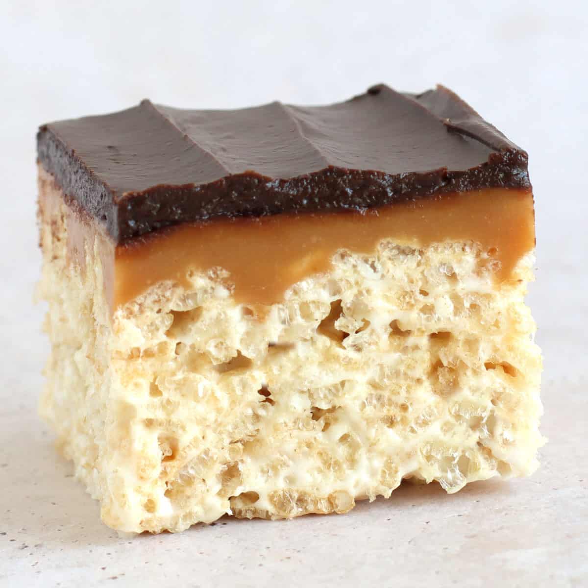 rice krispie treat bar topped with caramel and chocolate