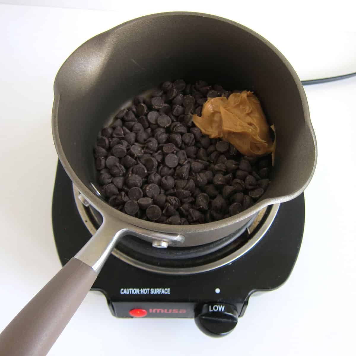 chocolate chips and peanut butter in small saucepan set over low heat