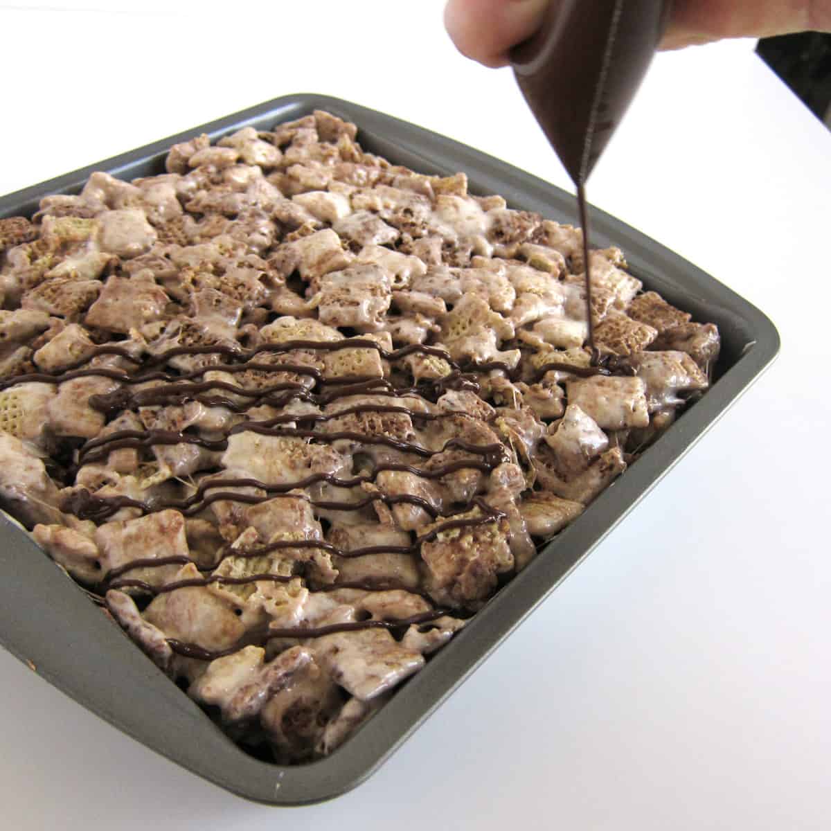 drizzle melted chocolate and Nutella over the chocolate Chex cereal treats