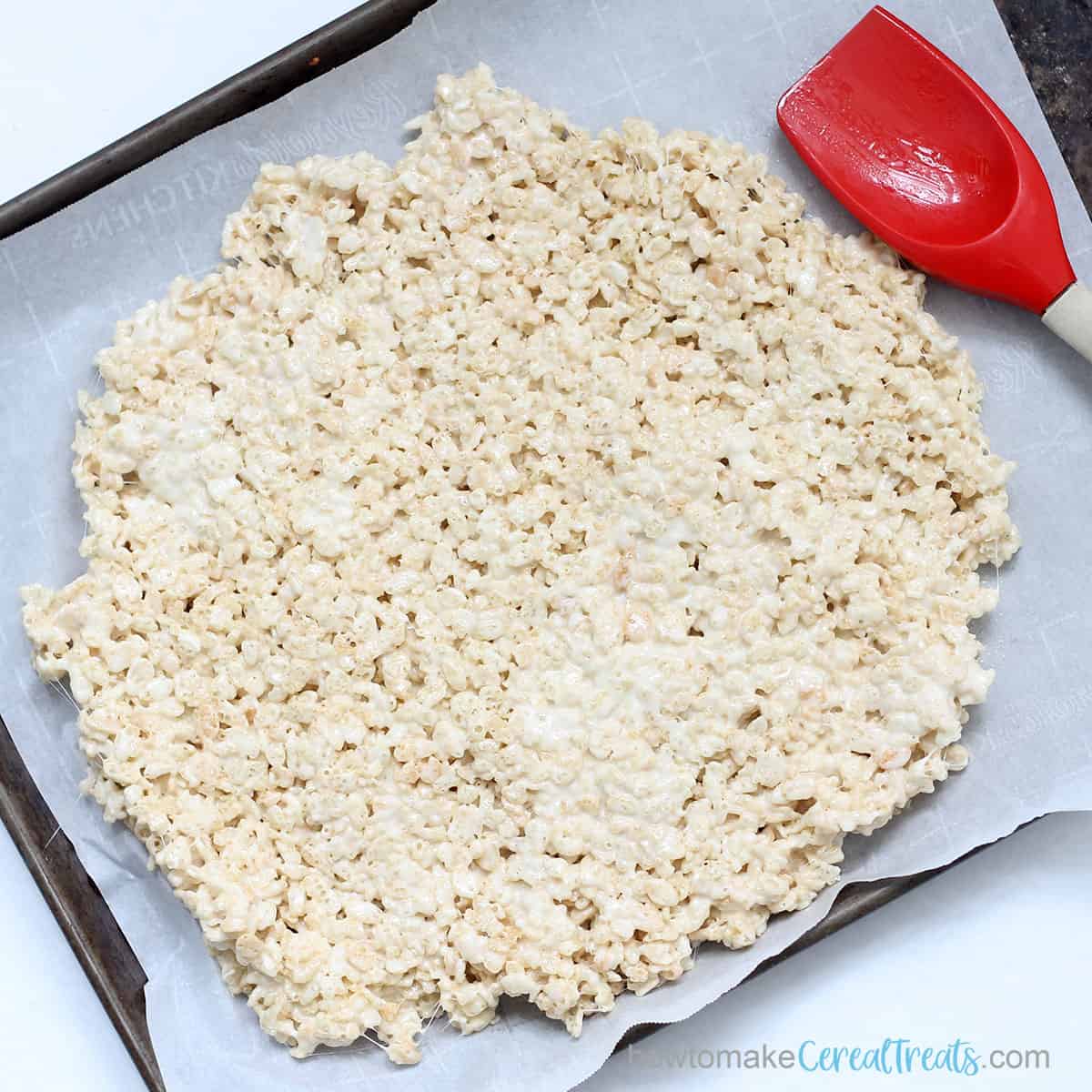 spreading Rice Krispie Treats on baking tray