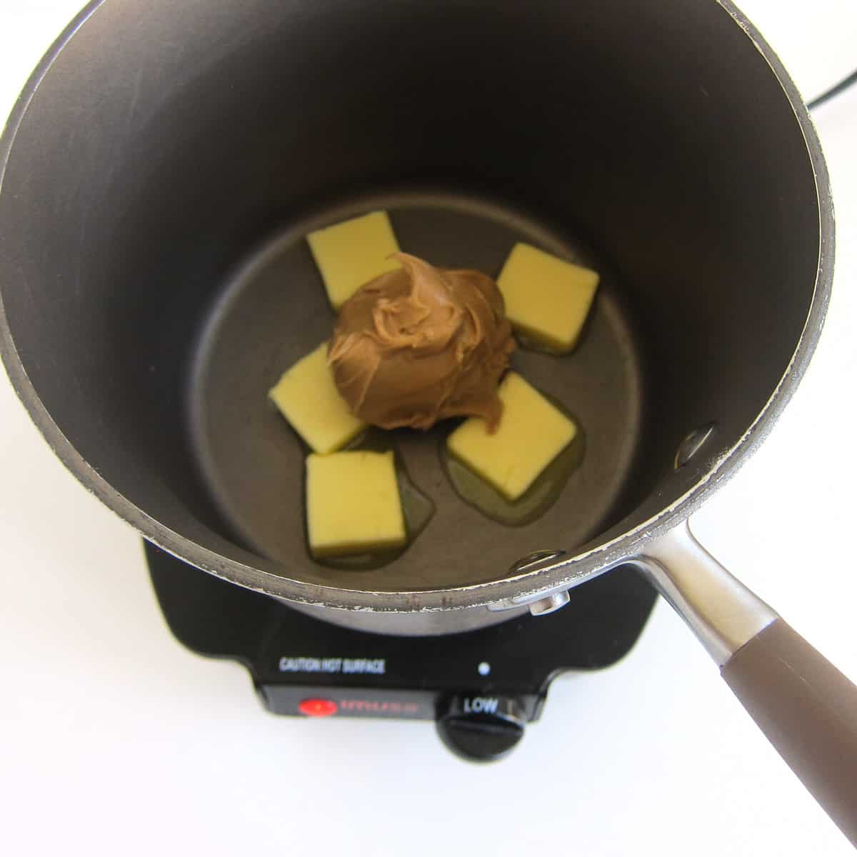 heat butter and peanut butter in a saucepan over low heat