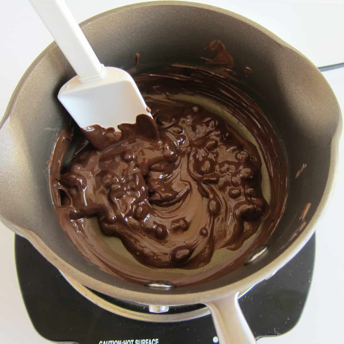 Stirring the melting chocolate chips and Nutella