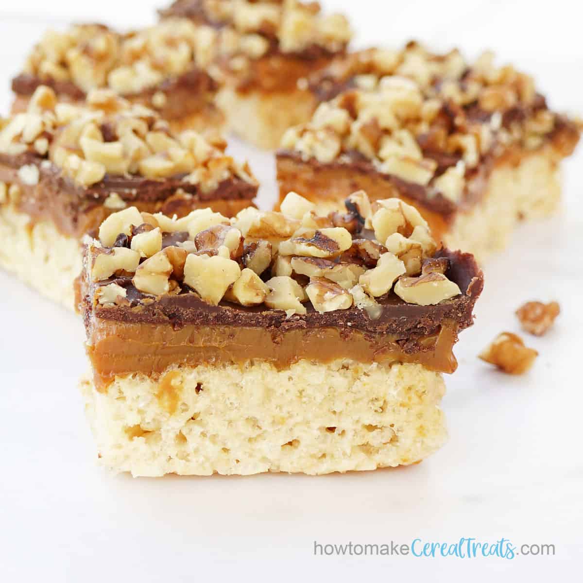 turtle rice crispy treats with chocolate ganache and caramel with pecans or walnuts