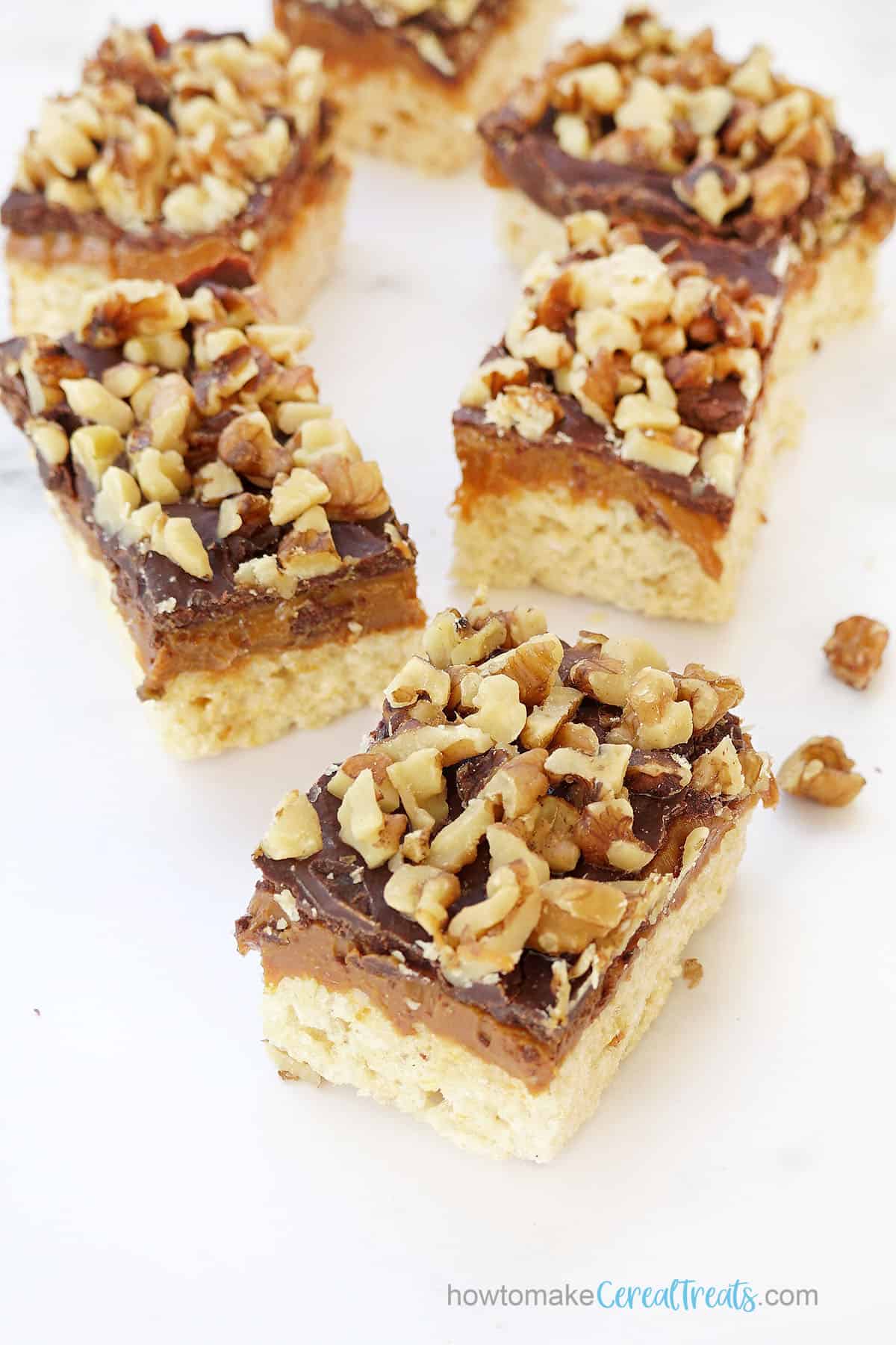 pecans or walnuts with dulce de leche and ganache on rice krispie treats