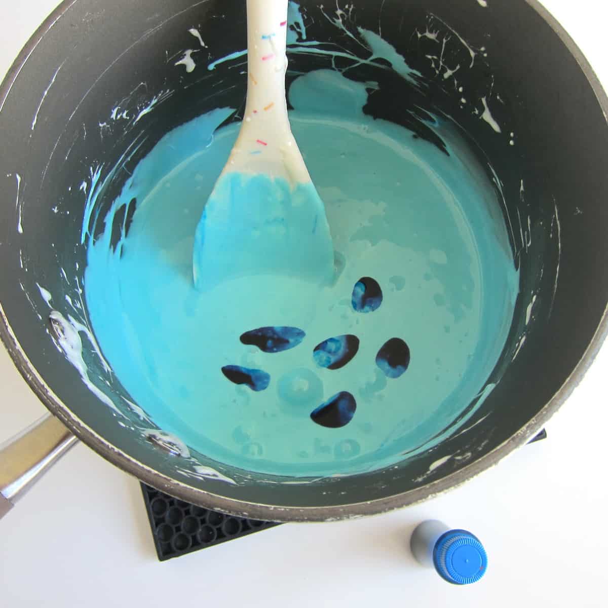 Add more drops of blue food coloring to the melted blue-colored marshmallows.