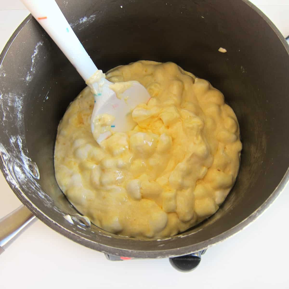 melting marshmallows and banana pudding mixed together with butter in a saucepan