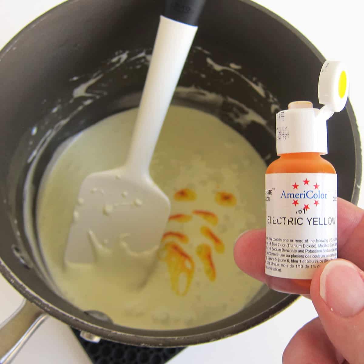 Coloring melted marshmallows and butter with AmeriColor Electric Yellow food coloring