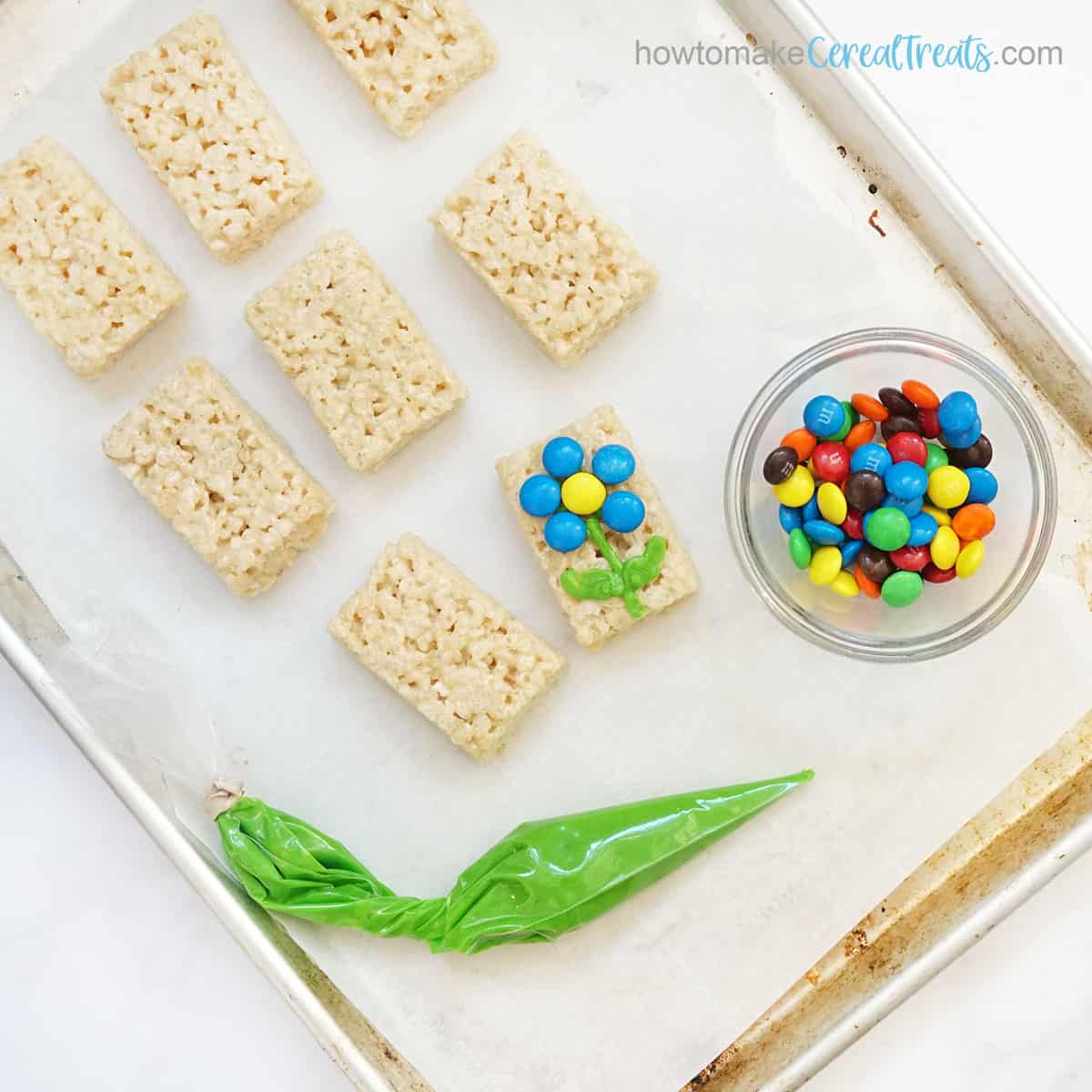decorating Rice Krispie Treats with icing and M and M candy