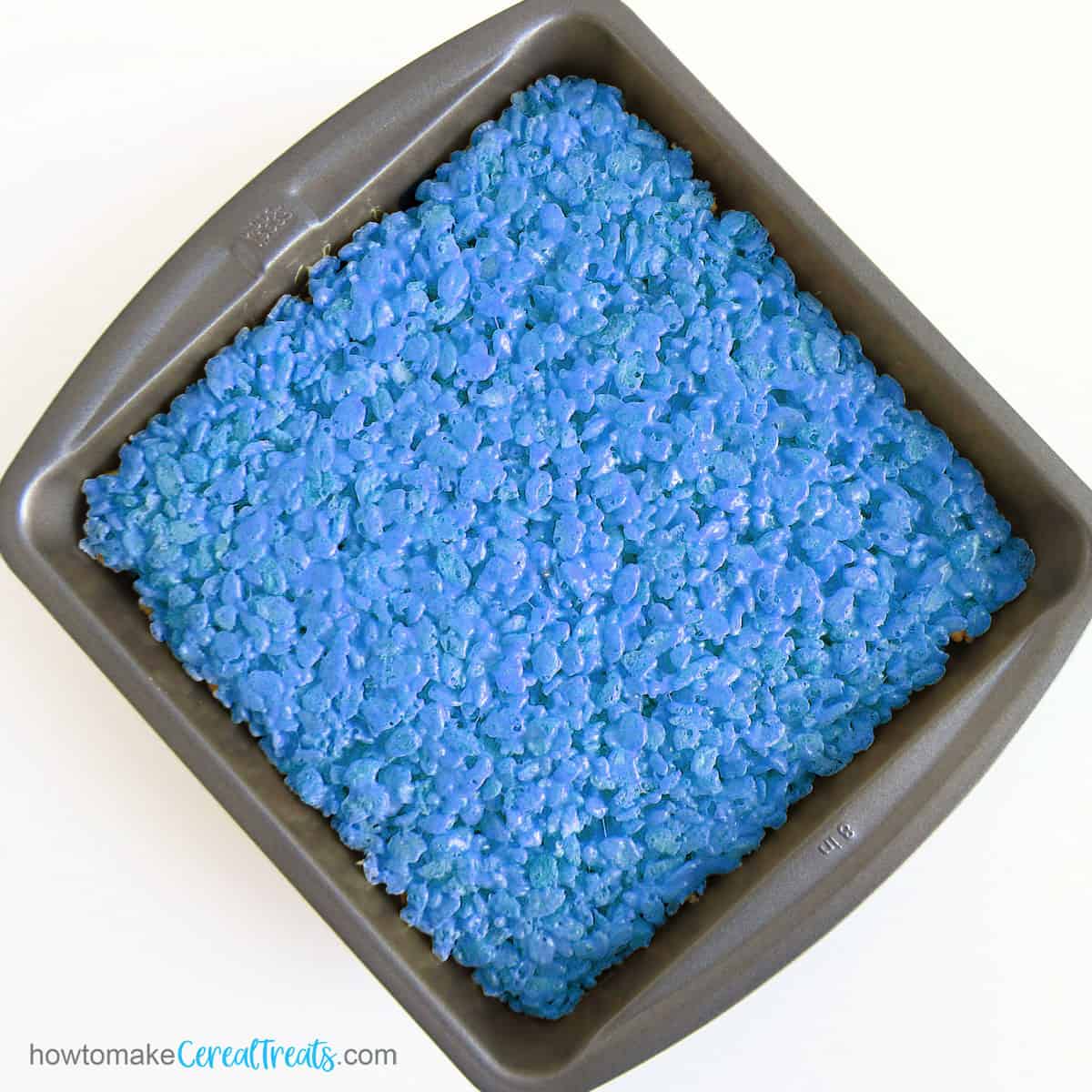 square pan filled with blue rice krispie treats