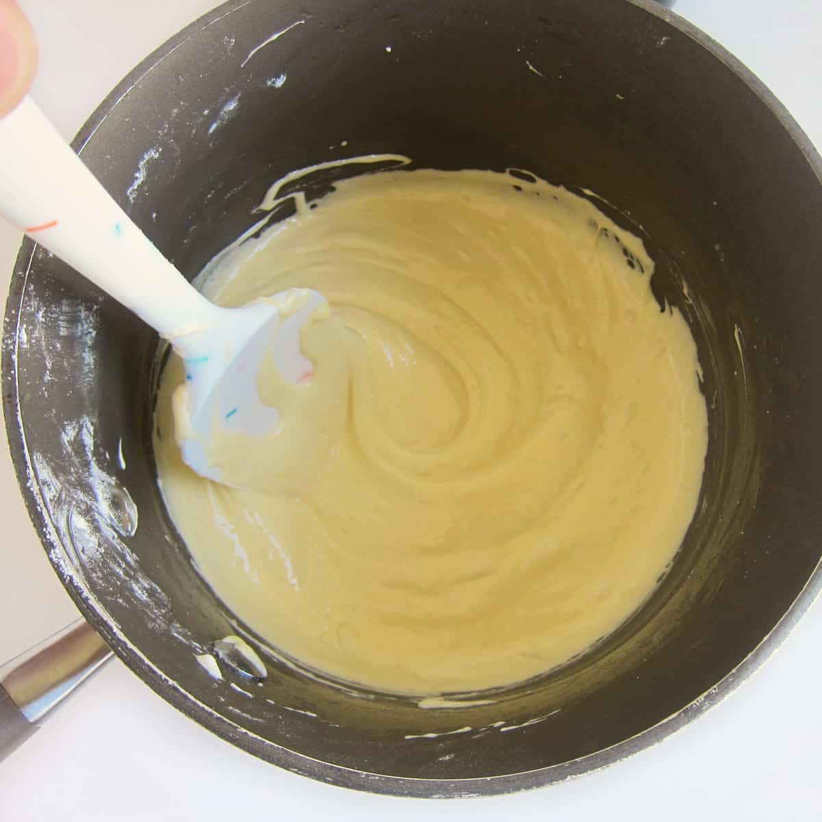 stirring melted butter, marshmallows, and banana pudding mix
