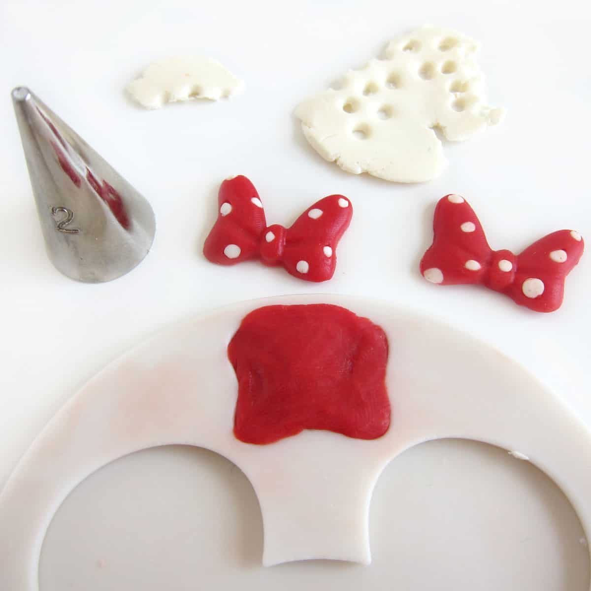 red and white polka dot Minnie Mouse bows made in a silicone mold using modeling chocolate