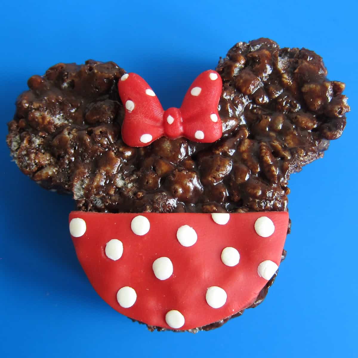 one Minnie Mouse chocolate rice Krispie treat decorated with red and white polka dot bow and dress
