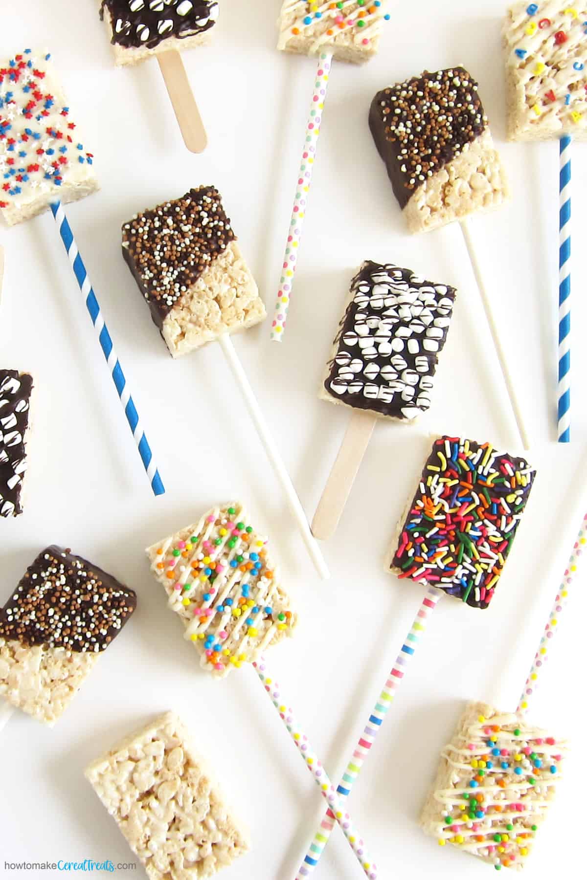 A variety of Rice Krispie Treat pops on a stick.