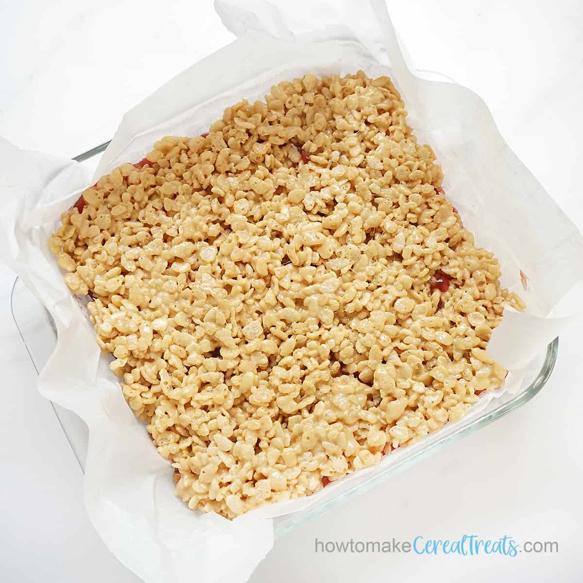 peanut butter and jelly rice krispie treats in baking pan