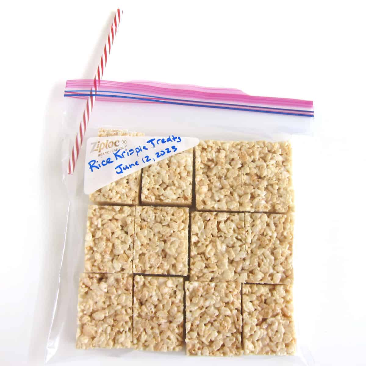 Remove air from a zip-top bag filled with Rice Krispie Treats using a straw.
