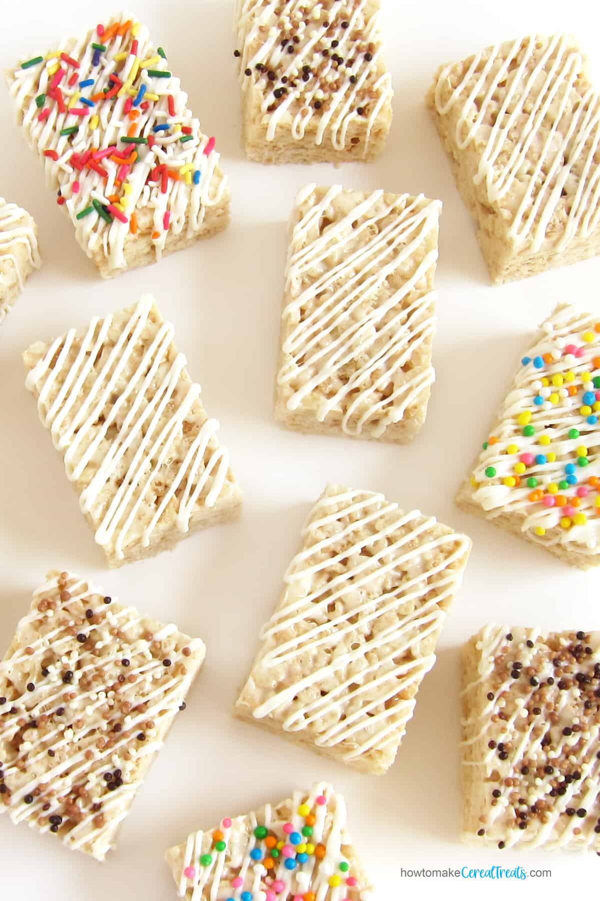 Rice Krispie Treats with white chocolate drizzle and sprinkles.