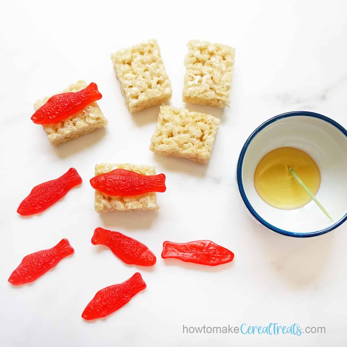 assembling nigiri Rice Krispie Treats sushi with Swedish fish