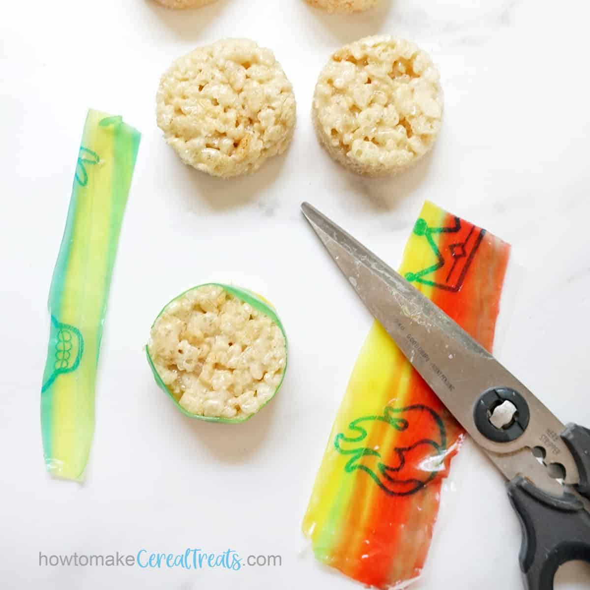assembling Rice Krispie Treats sushi craft with fruit rollups