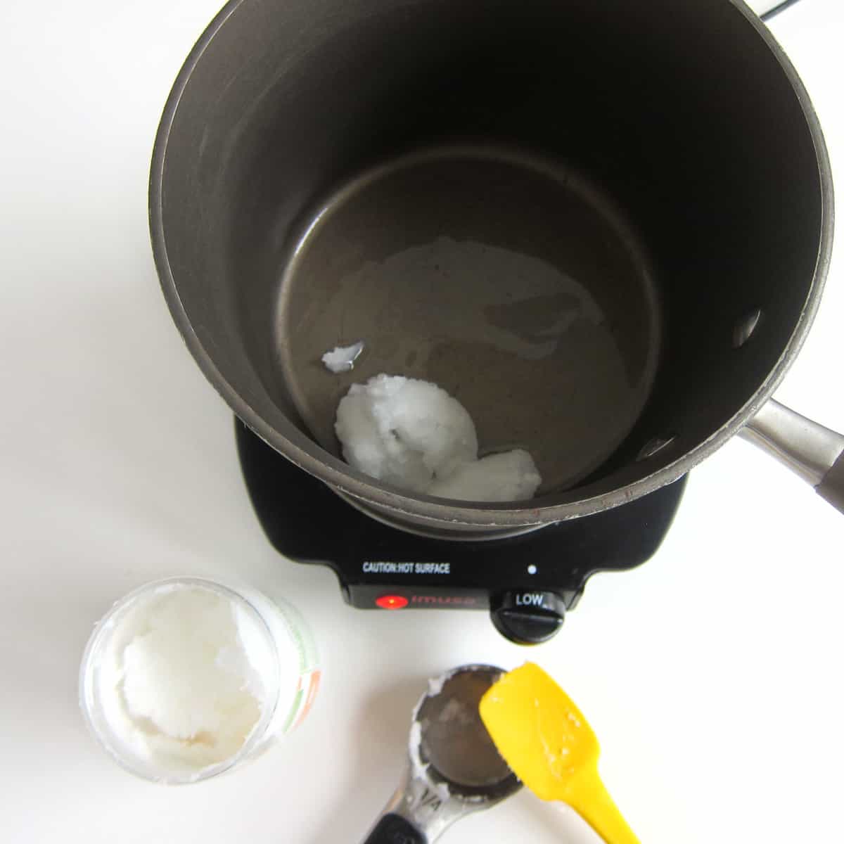 melting coconut oil in a saucepan set over low heat