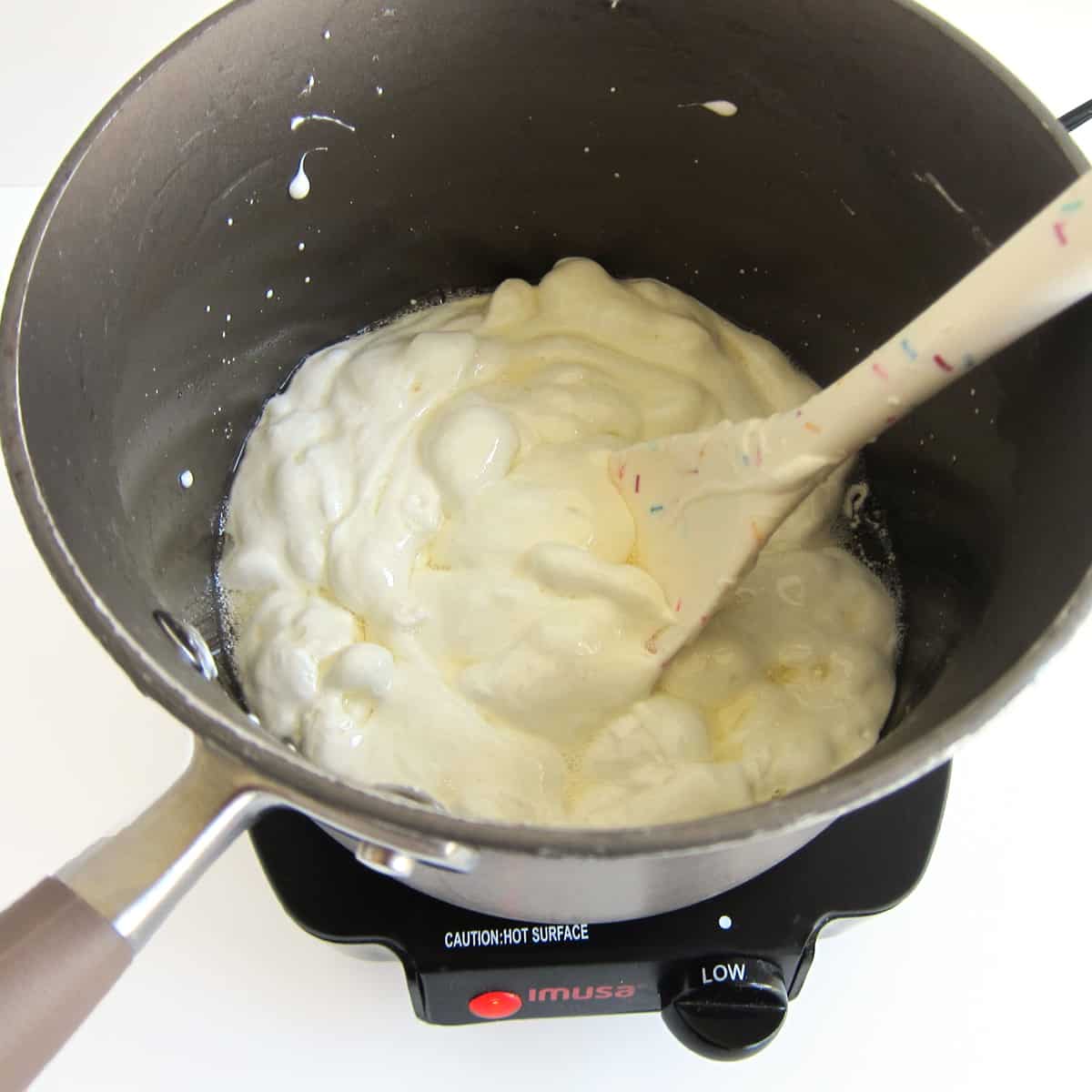 melting marshmallows with coconut oil in a non-stick saucepan set over low heat.