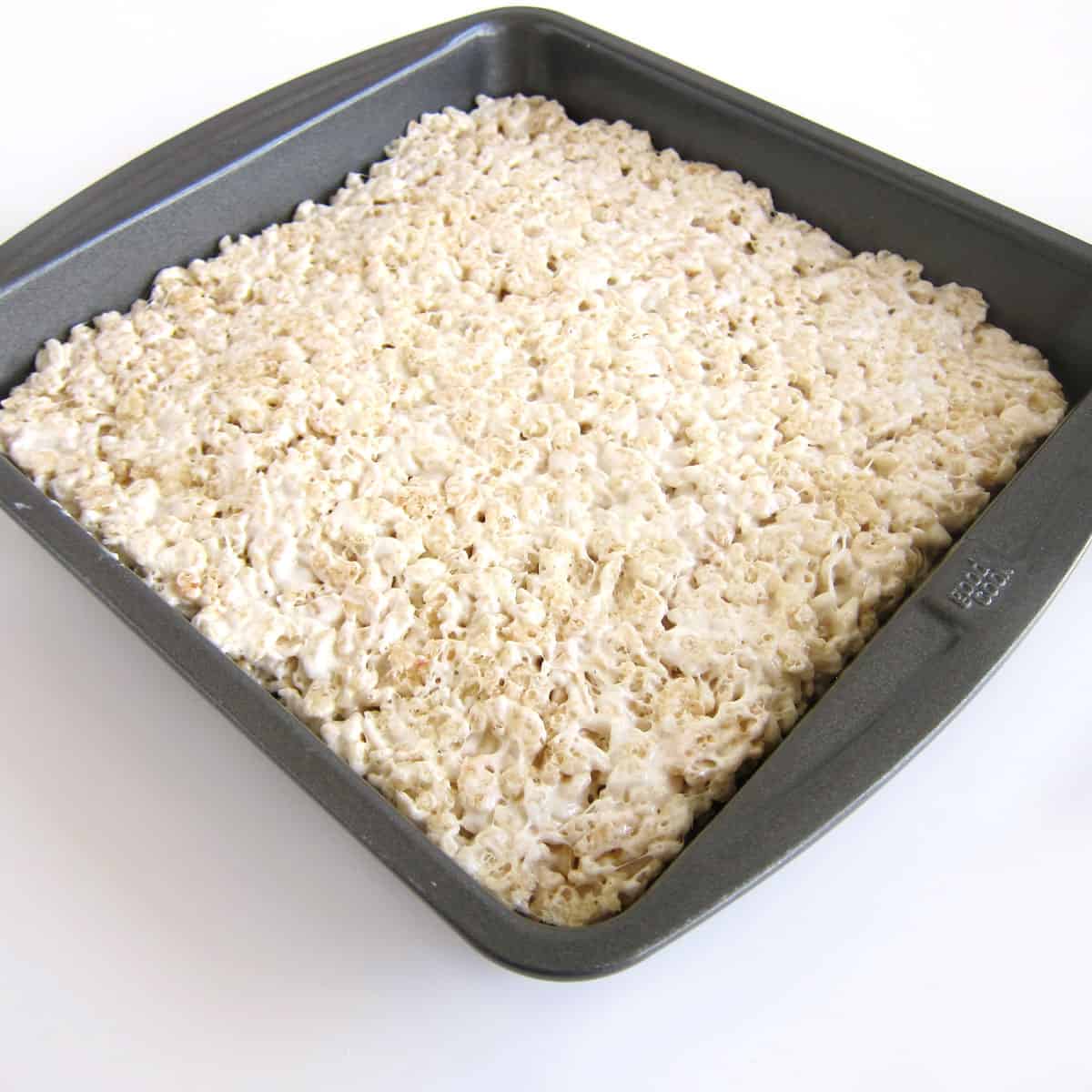 8-inch square pan filled with dairy-free Rice Krispie Treats. 