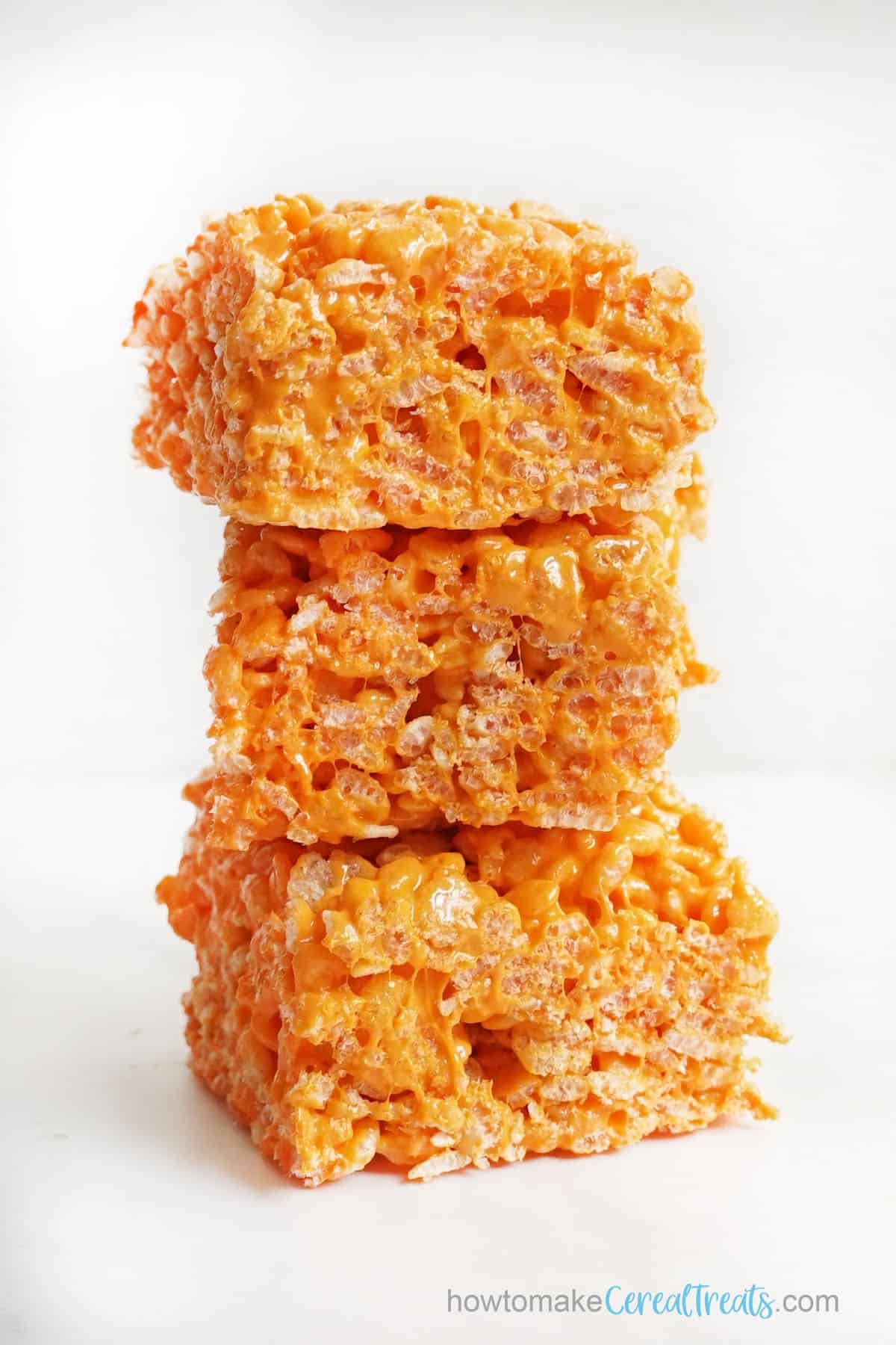 stack of orange Rice Crispy treats made with food coloring