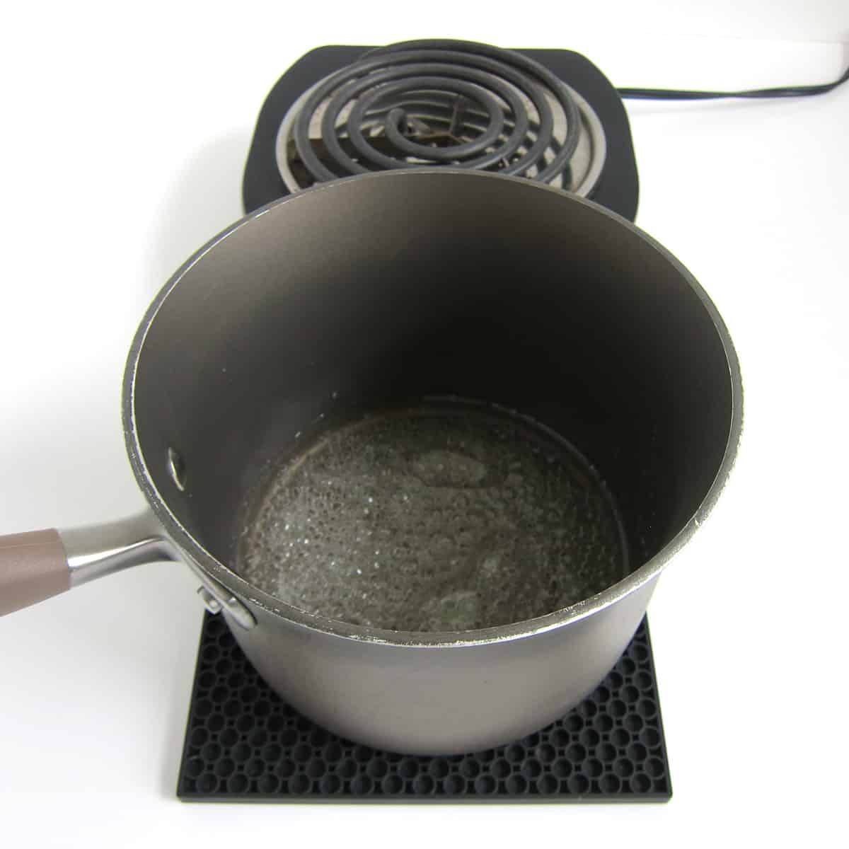 remove the pan of boiling corn syrup from the heat. 
