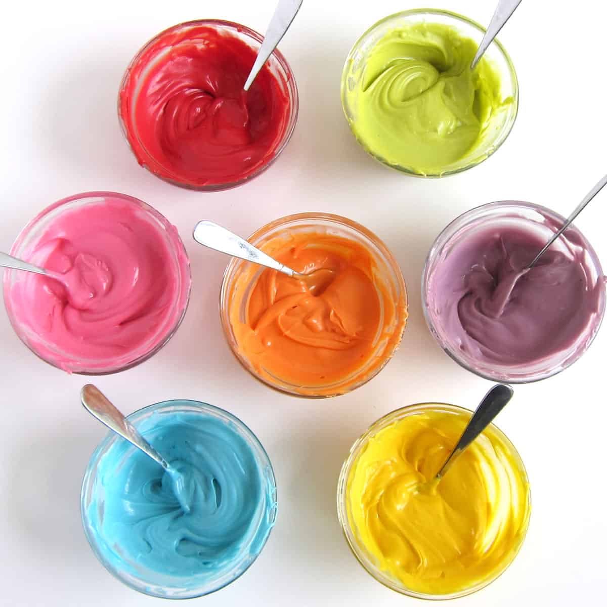 melted colored candy melts in ramekins.