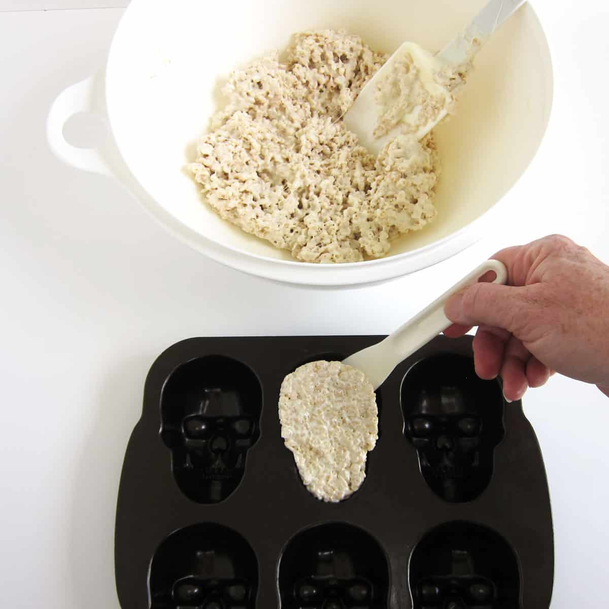 running a thin plastic blender spatula around the rice krispie treat skull to remove it from the skull pan.