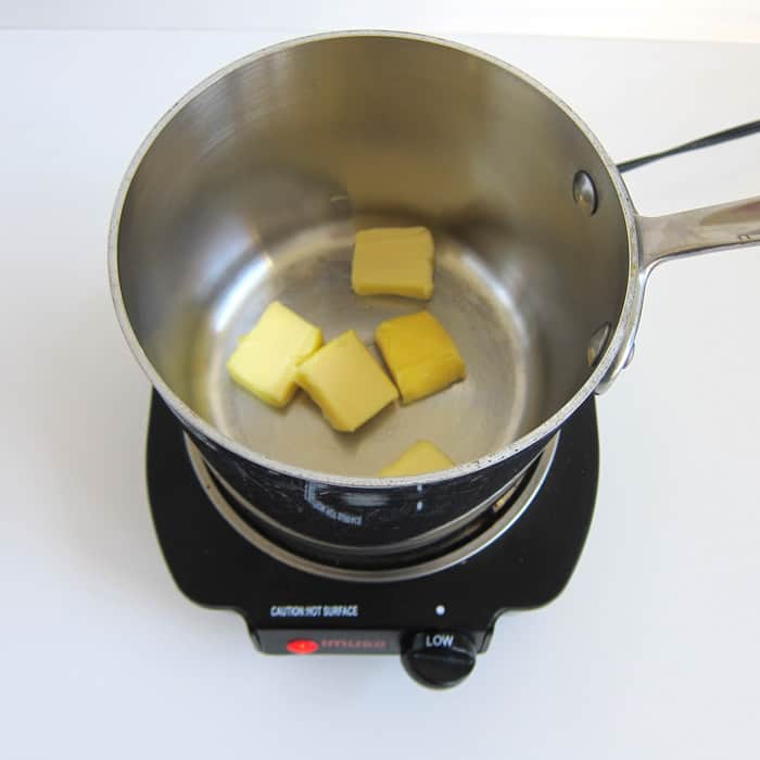 butter slices in a saucepan set over low heat.
