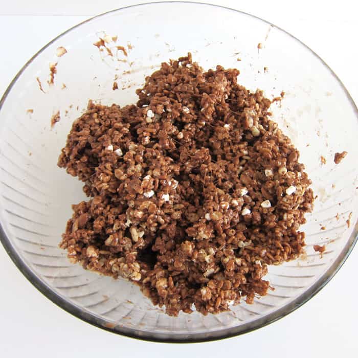 hot cocoa rice krispie treat mixture in mixing bowl.